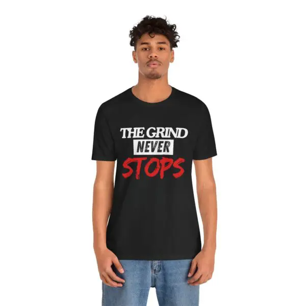 Man wearing "The Grind Never Stops" shirt.