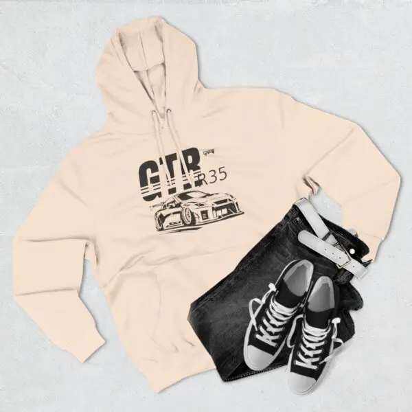 Beige hoodie, jeans, sneakers, and belt.