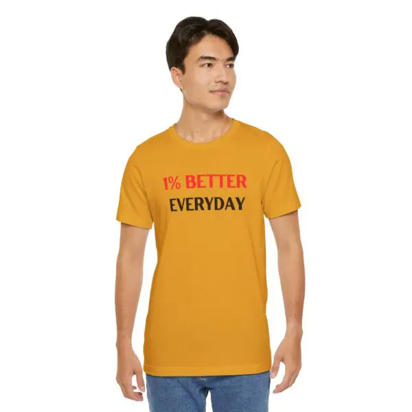 Man wearing yellow "1% Better Everyday" shirt.