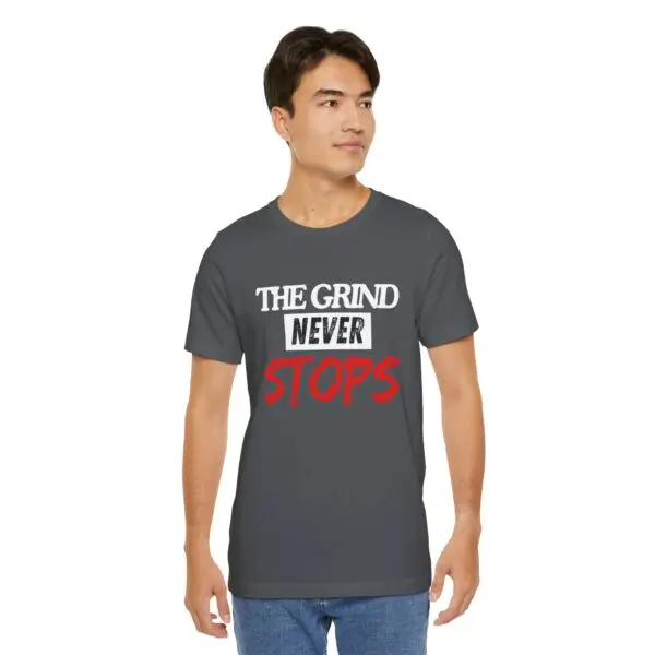 Man wearing "The Grind Never Stops" shirt.