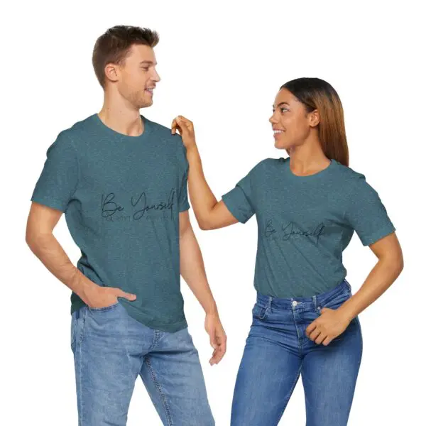 Two people in matching "Be Yourself" shirts.