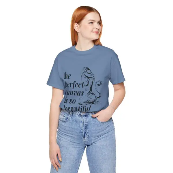Woman in blue graphic T-shirt smiling.