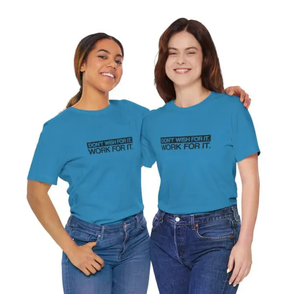 Two women wearing matching blue motivational shirts.