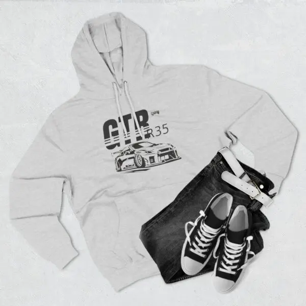 Gray hoodie, jeans, sneakers, and belt ensemble.