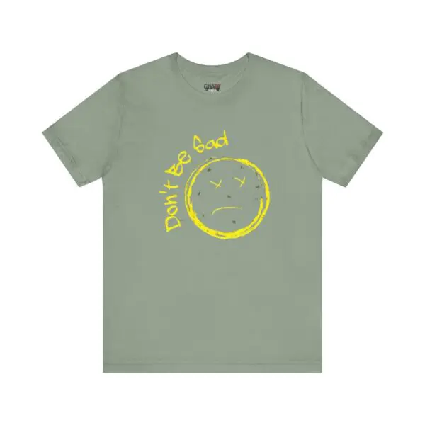 Green shirt with yellow sad face design.