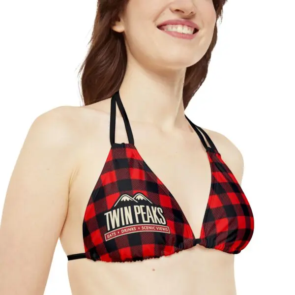 Woman wearing red plaid bikini top.