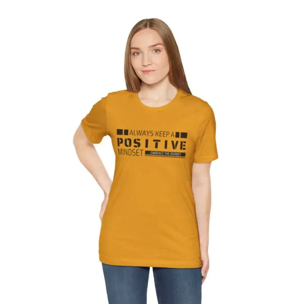 Woman wearing "Positive Mindset" yellow T-shirt.