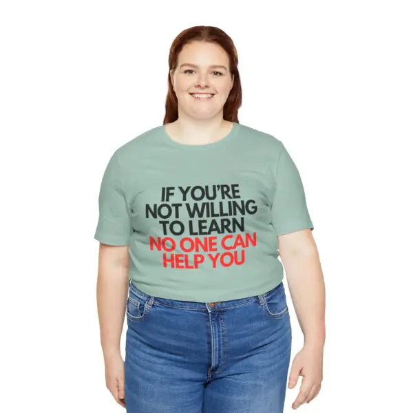 Smiling person wearing motivational quote t-shirt.