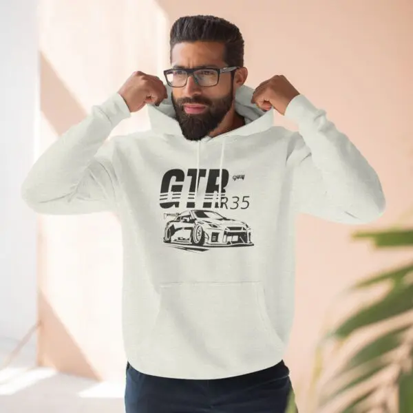 Man wearing GTR R35 hoodie indoors.
