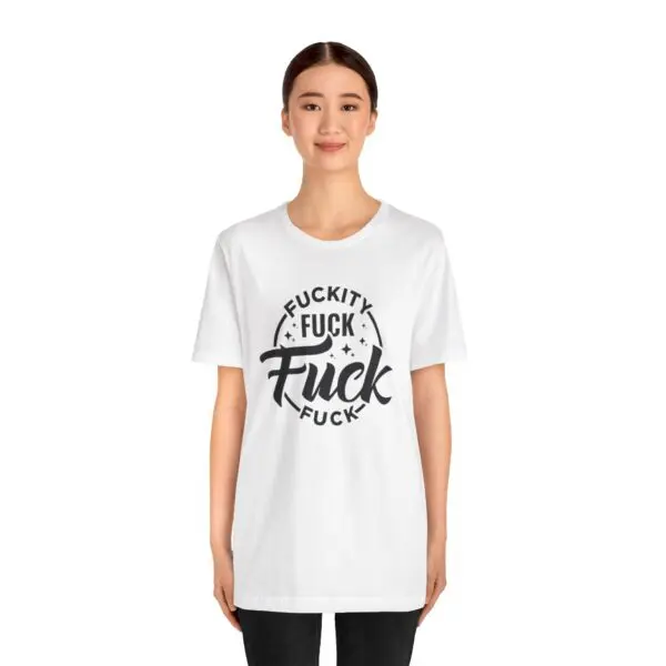 Person wearing a shirt with bold text.