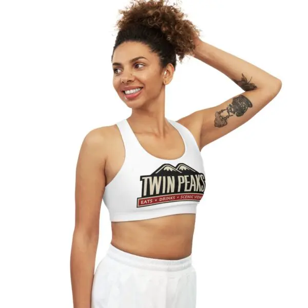 Smiling woman in Twin Peaks sports attire.
