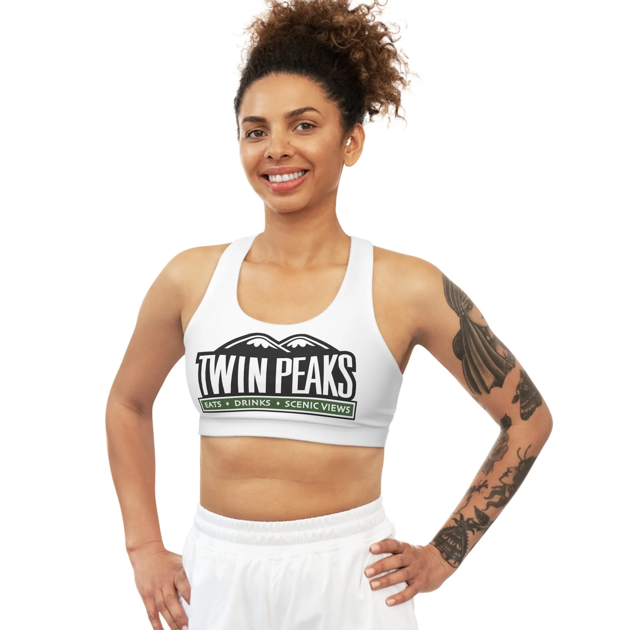 Woman smiling in Twin Peaks athletic attire.