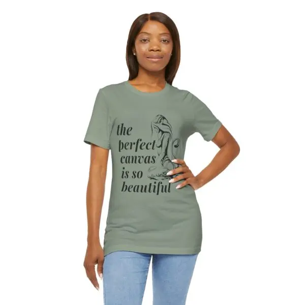 Woman wearing green graphic t-shirt, smiling.