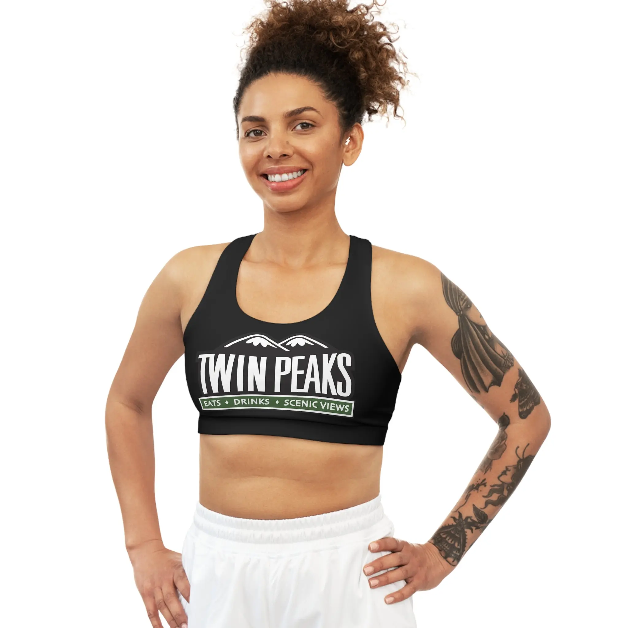 Smiling woman in Twin Peaks sports attire.