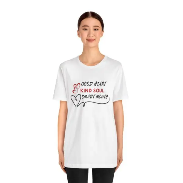 Woman wearing "Good Heart" graphic t-shirt.