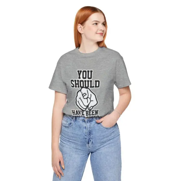 Woman in gray shirt with printed text.