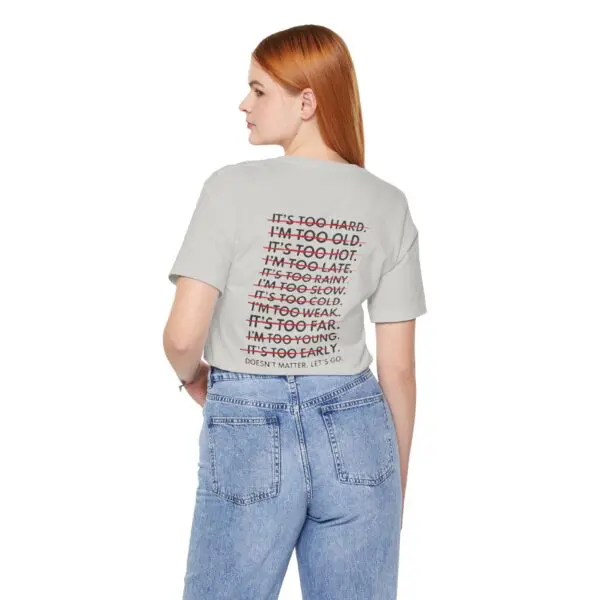 Woman in motivational text t-shirt and jeans.