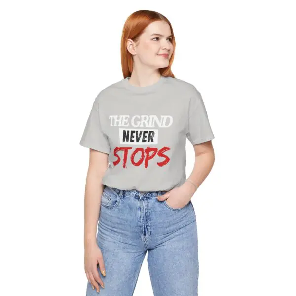 Woman wearing "The Grind Never Stops" t-shirt.