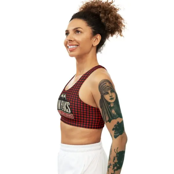Smiling woman with tattoos in athletic wear.