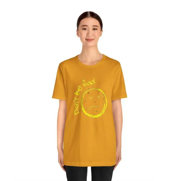Person wearing a yellow graphic t-shirt.