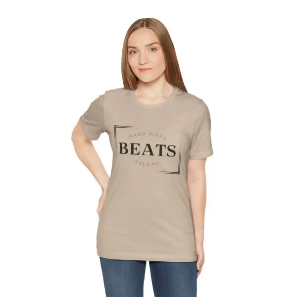 Woman wearing beige "Hard Work Beats Talent" shirt.