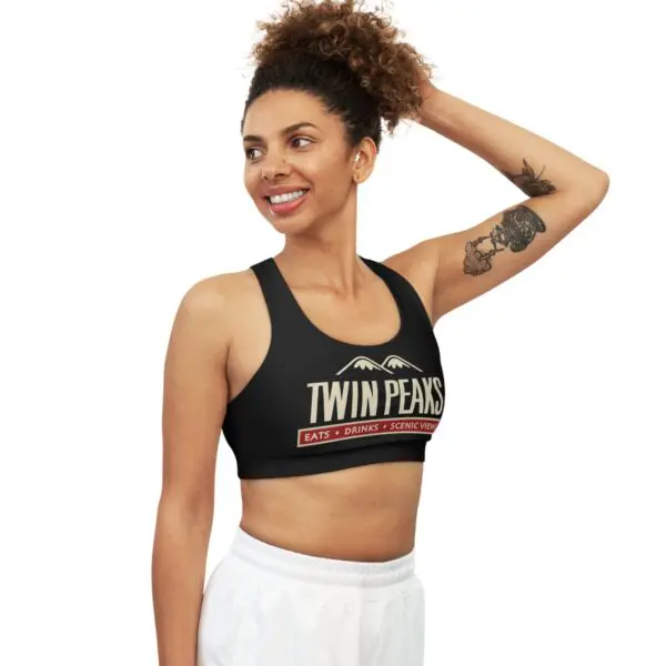 Smiling woman wearing Twin Peaks sports bra.