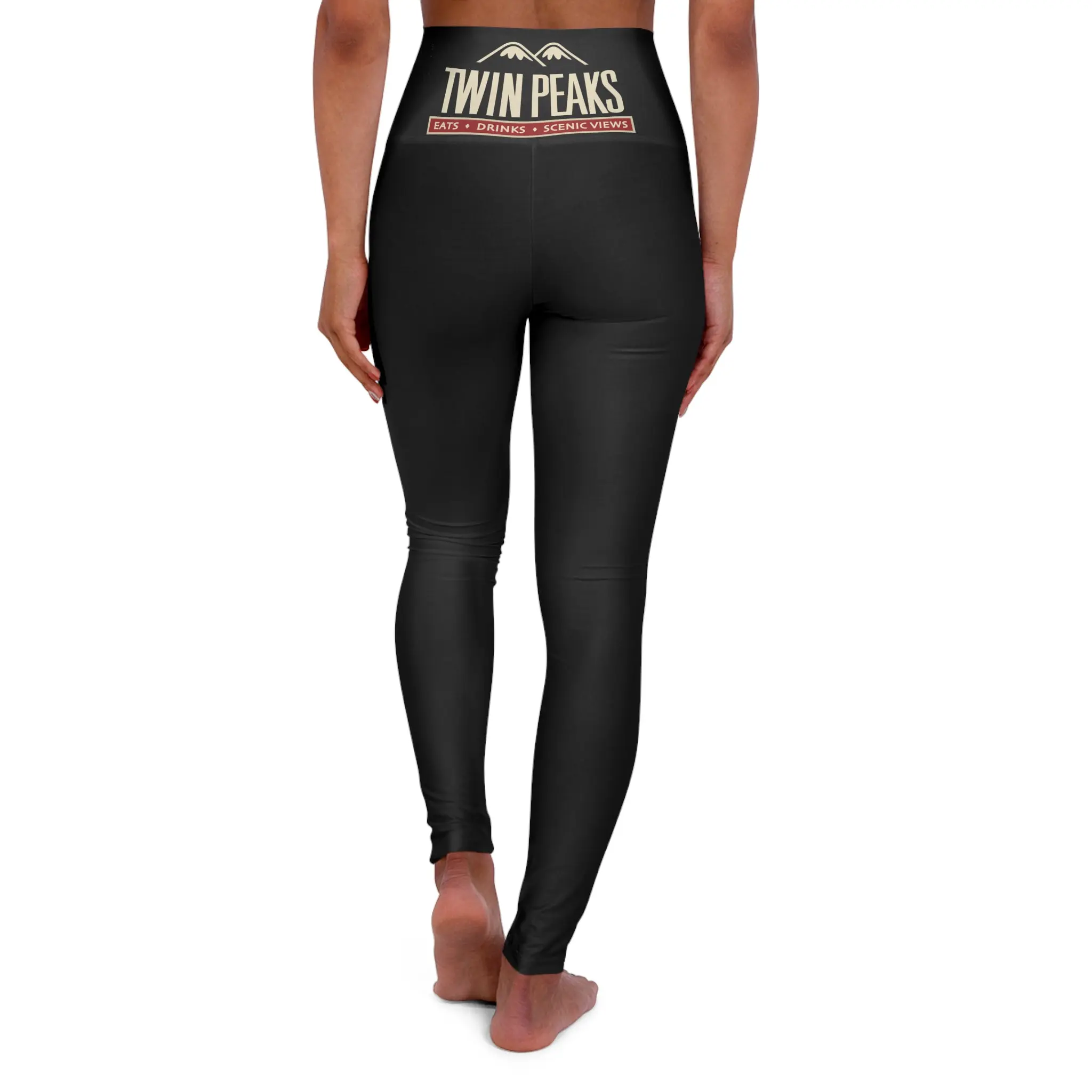 Woman wearing black Twin Peaks leggings, rear view.