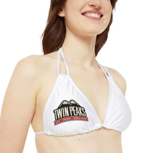 Smiling woman wearing Twin Peaks bikini top.