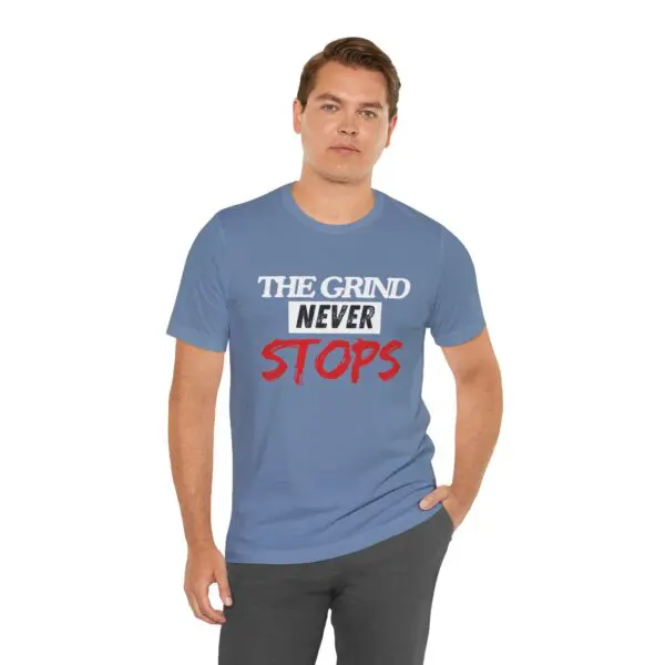 Man wearing "The Grind Never Stops" shirt.