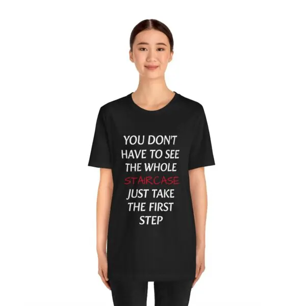 Woman wearing motivational quote T-shirt.