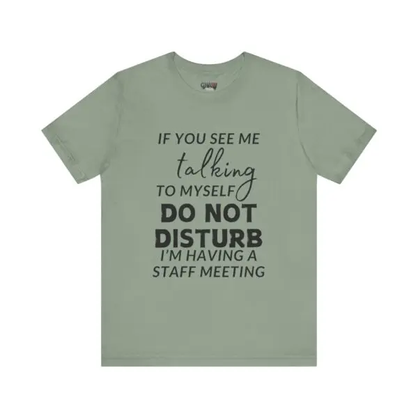 Green T-shirt with humorous text design.