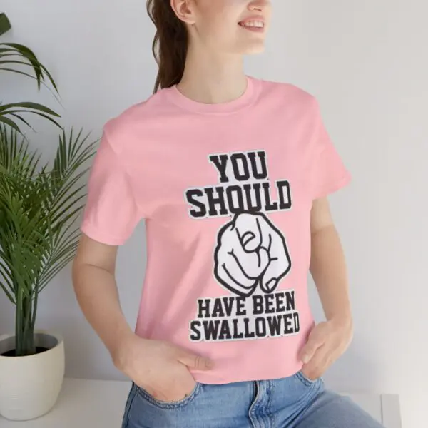 Woman in pink shirt with bold text.