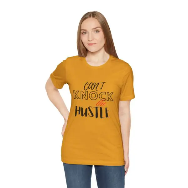 Woman wearing "Can't Knock the Hustle" shirt.
