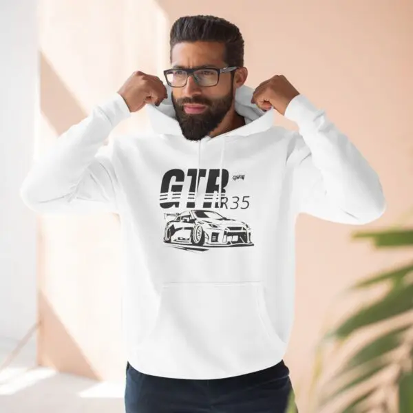 Man wearing GTR hoodie indoors.