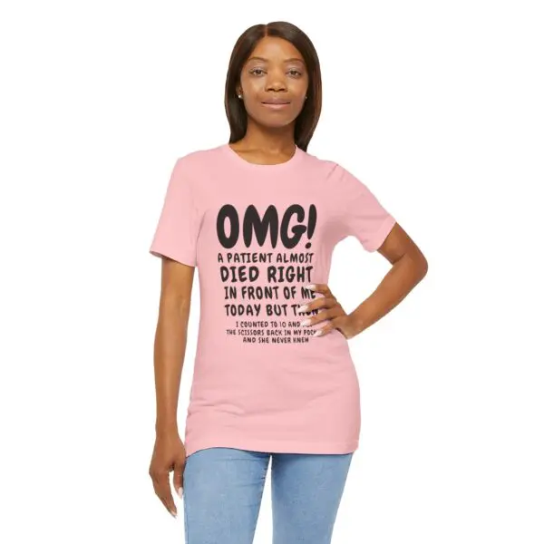 Woman wearing a pink graphic t-shirt.