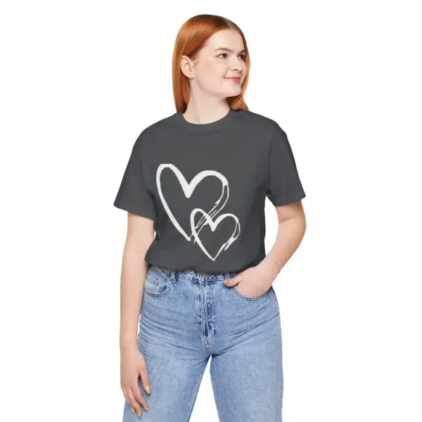 Woman in heart-print t-shirt smiling.