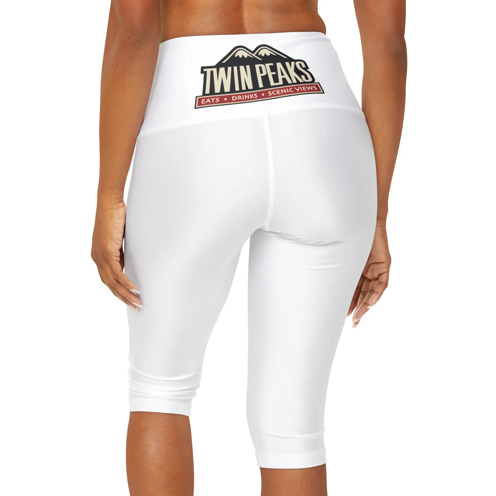 Woman wearing white leggings, Twin Peaks logo.