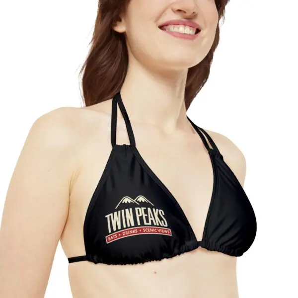 Woman wearing black Twin Peaks bikini top.