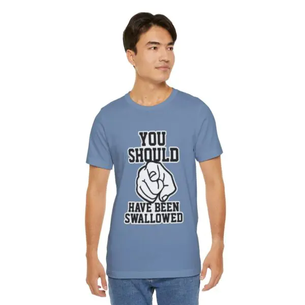 Man wearing humorous graphic t-shirt, blue background.