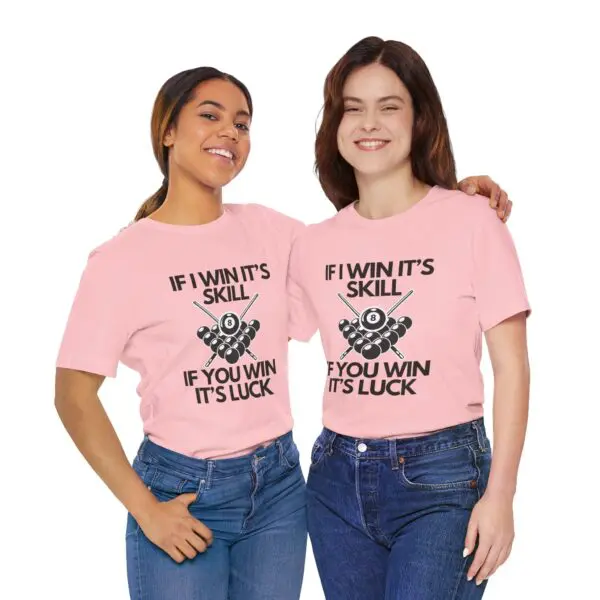 Two women wearing matching pink shirts.