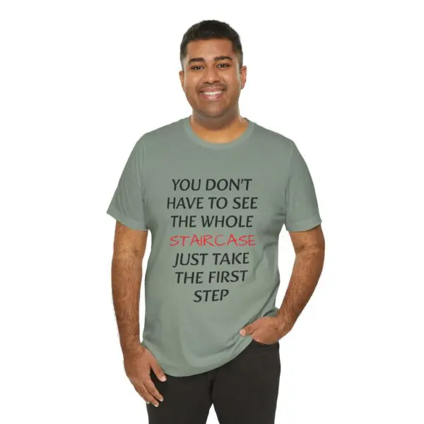 Man wearing inspirational quote t-shirt, smiling.