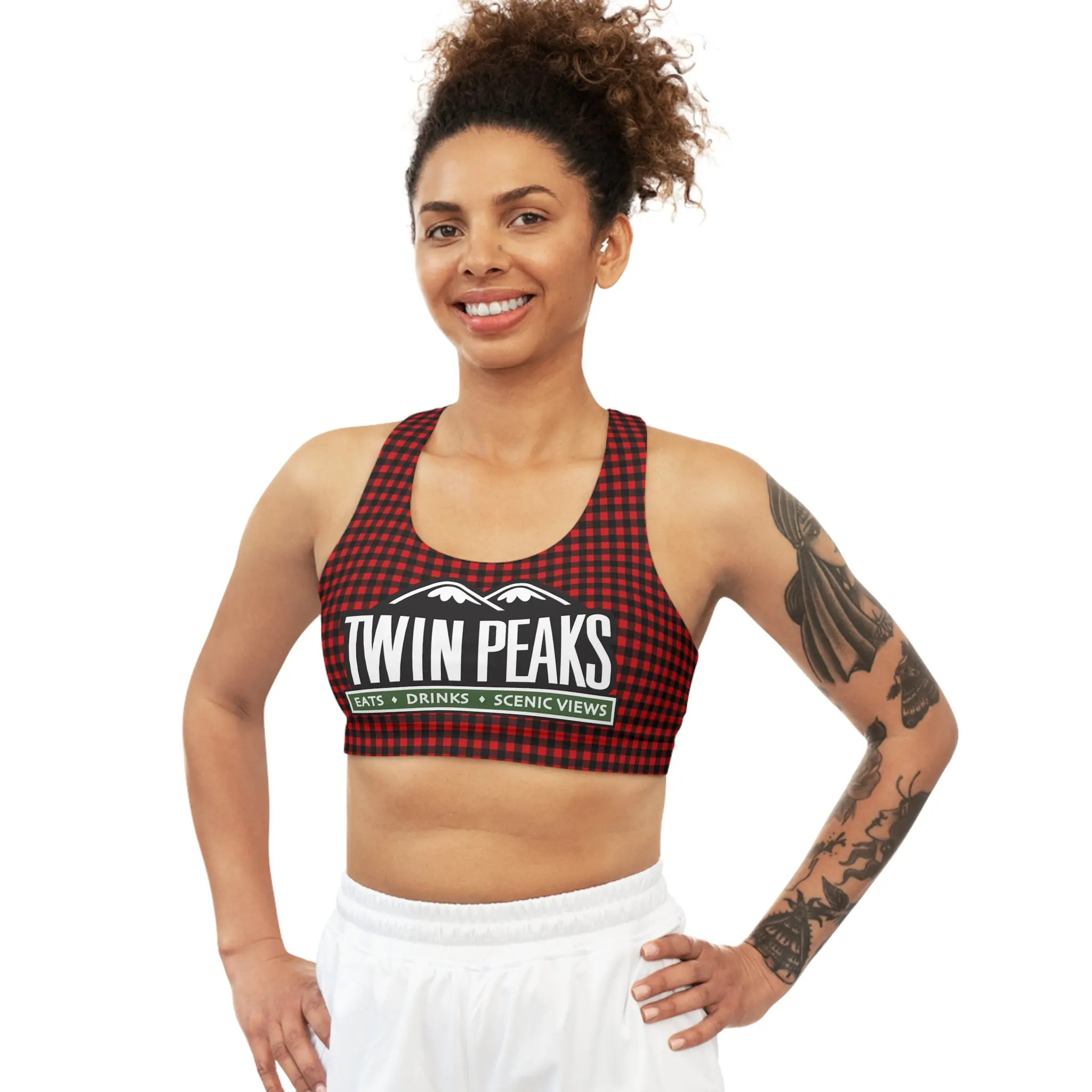 Smiling woman in a sports bra.