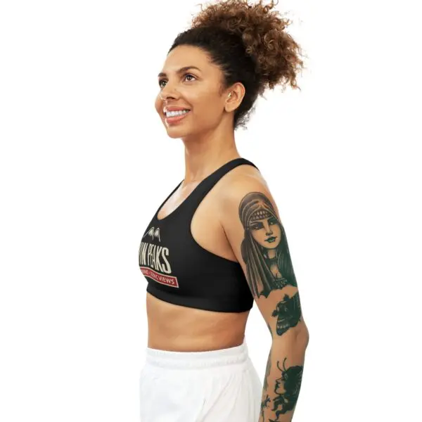 Smiling woman with arm tattoos in profile.