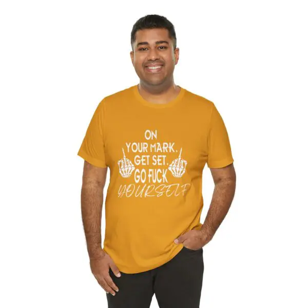 Man wearing humorous graphic t-shirt, smiling.