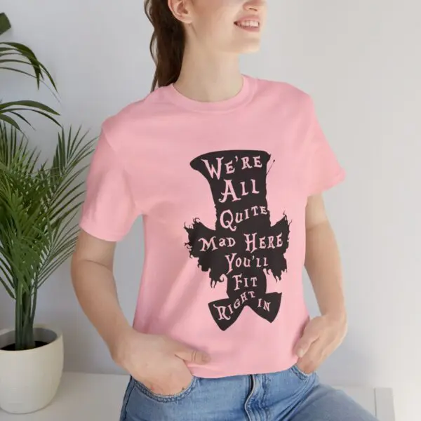 Woman wearing pink shirt with whimsical quote.