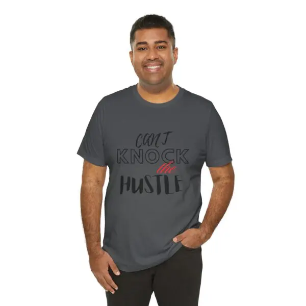 Man wearing "Can't Knock the Hustle" shirt.