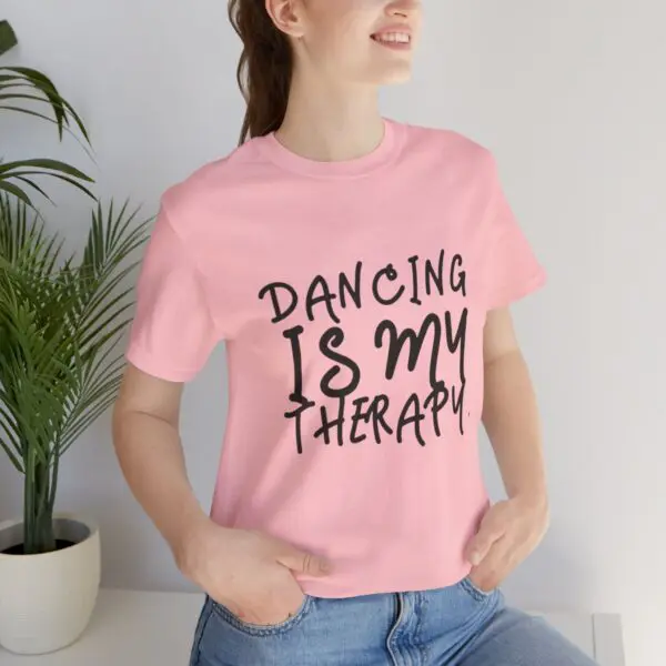 Woman wearing "Dancing is My Therapy" shirt.