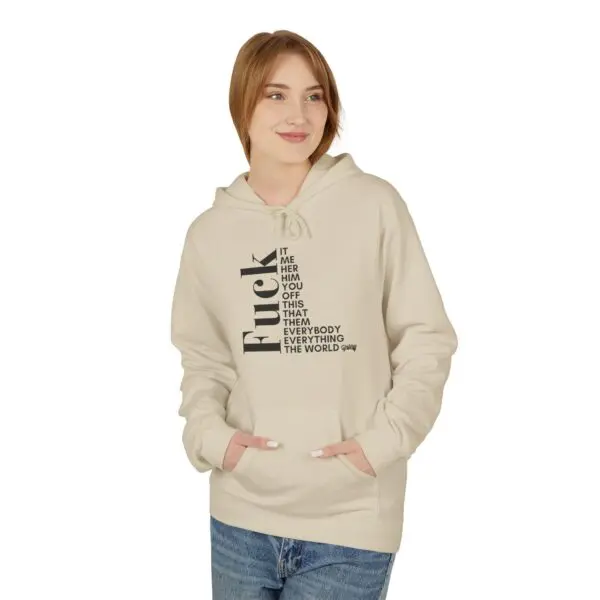 Woman wearing beige hoodie with text design.