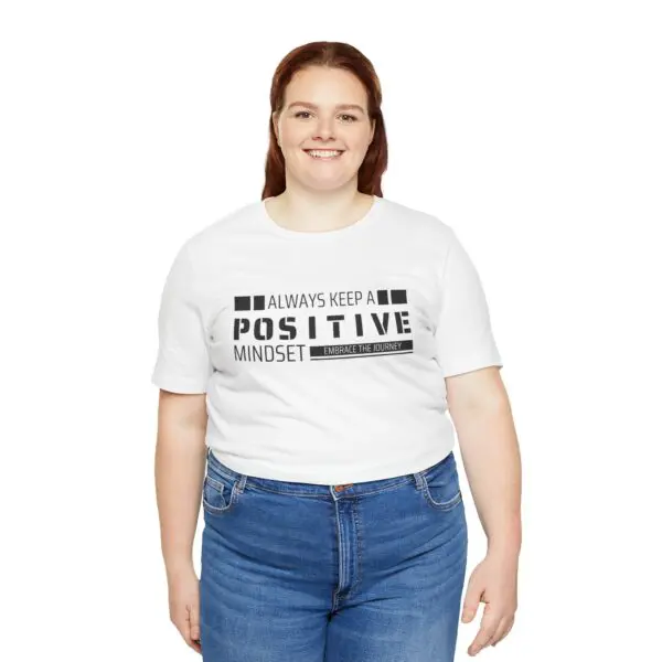 Smiling person wearing positive message T-shirt.