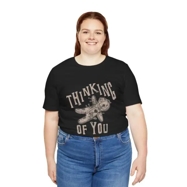 Woman wearing "Thinking of You" T-shirt.
